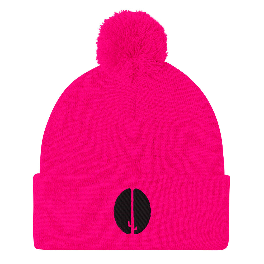 A pink beanie with a pom-pom on top and a black saguaro bean embroidery on the front.